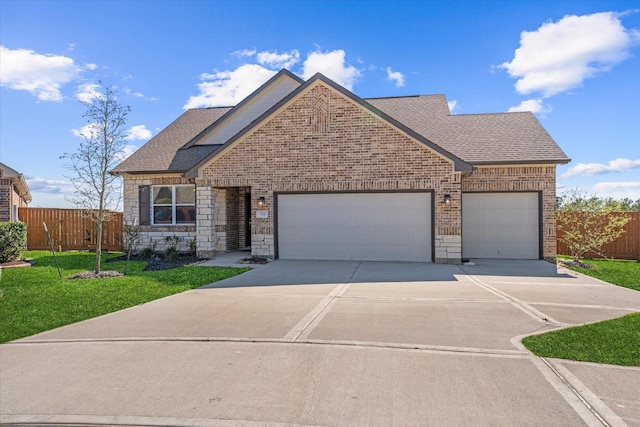 770 Dogberry Ct, Conroe, TX 77304 - view of front of home with concrete driveway, an attached garage, brick siding, and a shingled roof