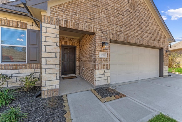 770 Dogberry Ct, Conroe, TX 77304 - entrance to property with a garage, brick siding, driveway, and stone siding