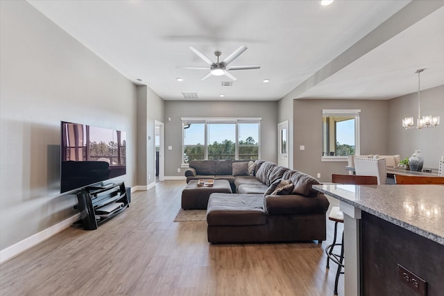770 Dogberry Ct, Conroe, TX 77304 - living area featuring light wood finished floors, baseboards, ceiling fan, a chandelier, and recessed lighting