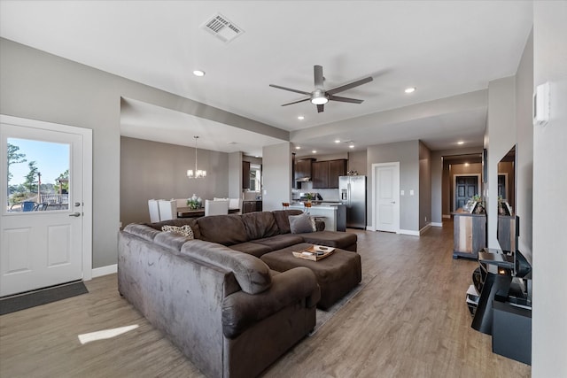 770 Dogberry Ct, Conroe, TX 77304 - living area featuring light wood finished floors, baseboards, a chandelier, recessed lighting, and a ceiling fan