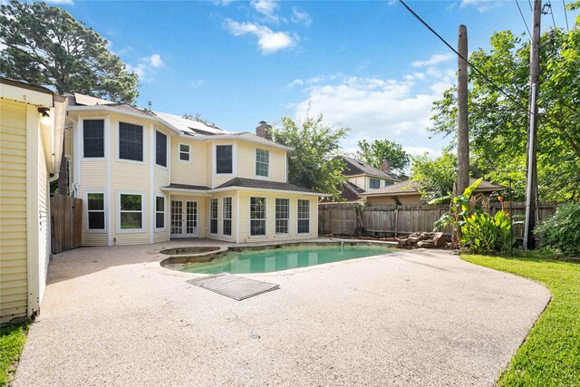 18011 Tall Cypress Dr, Spring, TX 77388 - view of swimming pool with a patio area, a fenced backyard, french doors, and a pool with connected hot tub