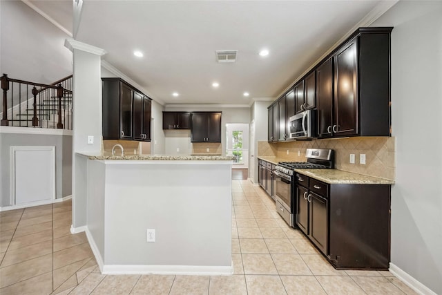 13614 Heath Spring Ct, Houston, TX 77044 - kitchen with appliances with stainless steel finishes, light tile patterned floors, decorative backsplash, crown molding, and light stone countertops