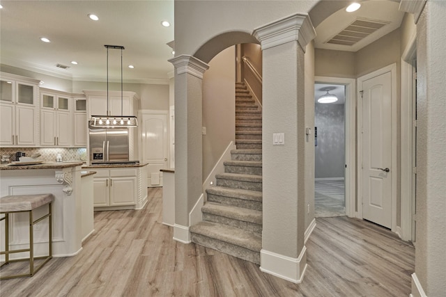 15471 Castlebrook Ct, Montgomery, TX 77316 - kitchen with ornate columns, stainless steel built in fridge, light wood-style flooring, crown molding, and recessed lighting