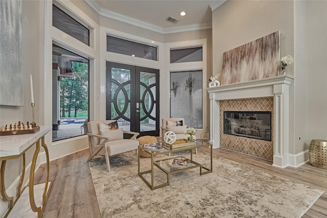 15471 Castlebrook Ct, Montgomery, TX 77316 - living area featuring crown molding, wood finished floors, french doors, a tile fireplace, and recessed lighting