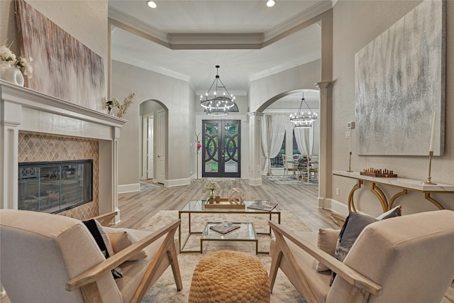 15471 Castlebrook Ct, Montgomery, TX 77316 - living room featuring arched walkways, a chandelier, wood finished floors, a fireplace, and recessed lighting