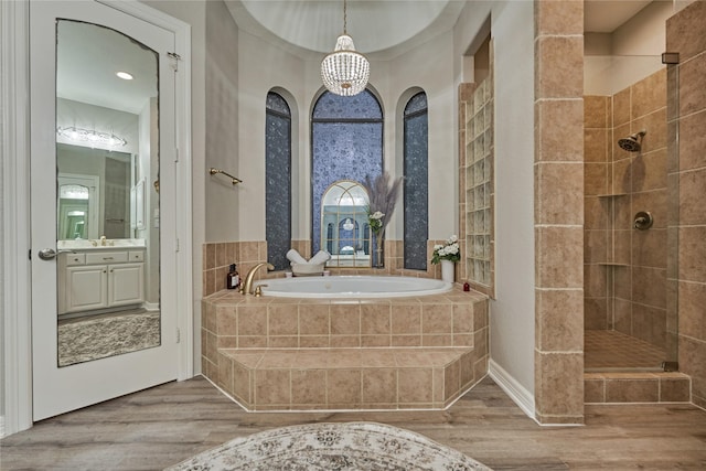 15471 Castlebrook Ct, Montgomery, TX 77316 - full bathroom featuring tiled shower, wood finished floors, a garden tub, and a chandelier