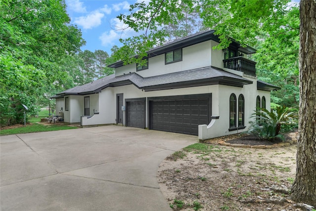 15471 Castlebrook Ct, Montgomery, TX 77316 - view of front of house with a balcony, stucco siding, concrete driveway, an attached garage, and roof with shingles
