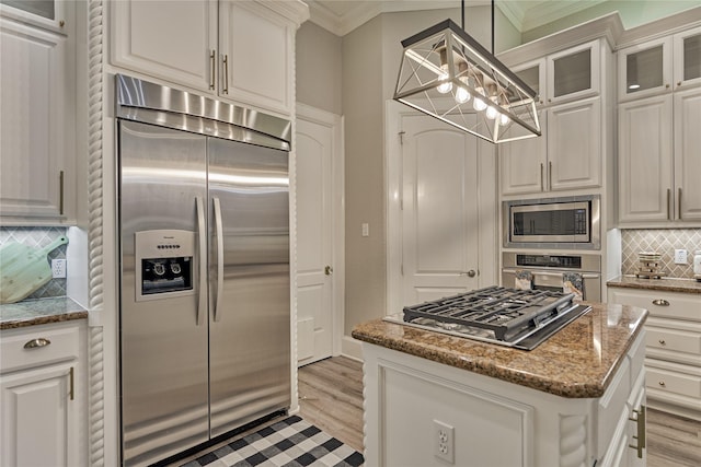 15471 Castlebrook Ct, Montgomery, TX 77316 - kitchen with built in appliances, crown molding, decorative backsplash, glass insert cabinets, and stone countertops