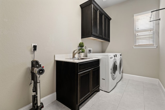 2037 Capriccio Dr, Spring, TX 77386 - laundry area featuring cabinet space, washer and clothes dryer, baseboards, and light tile patterned floors
