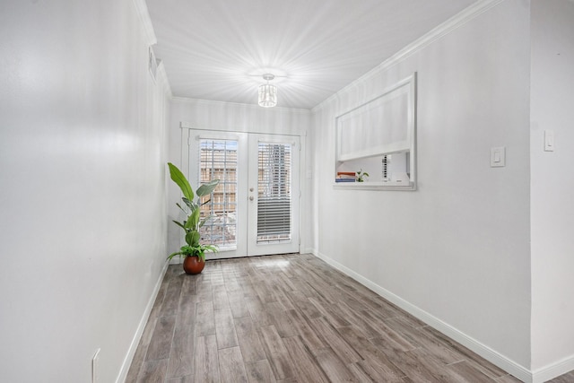8245 Kingsbrook Rd Unit 139, Houston, TX 77024 - spare room featuring baseboards, crown molding, french doors, and wood finished floors