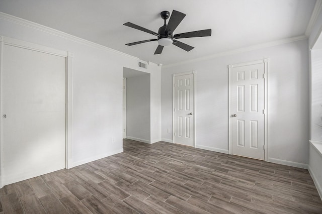 8245 Kingsbrook Rd Unit 139, Houston, TX 77024 - unfurnished bedroom featuring wood finished floors, ornamental molding, baseboards, and a ceiling fan