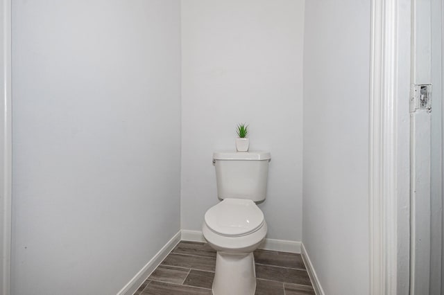 8245 Kingsbrook Rd Unit 139, Houston, TX 77024 - bathroom featuring toilet, baseboards, and wood finished floors