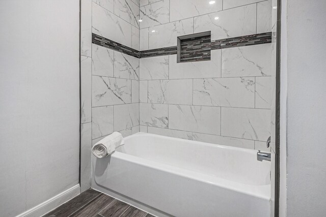 8245 Kingsbrook Rd Unit 139, Houston, TX 77024 - bathroom featuring wood finished floors, baseboards, and shower / tub combination