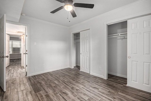 8245 Kingsbrook Rd Unit 139, Houston, TX 77024 - unfurnished bedroom with multiple closets, wood finished floors, baseboards, and ornamental molding