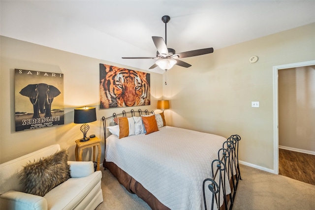 carpeted bedroom featuring baseboards and ceiling fan