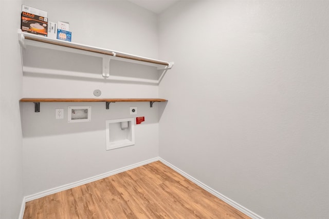 11355 Dawn Beach Ln, Conroe, TX 77304 - washroom with hookup for an electric dryer, hookup for a washing machine, light wood-style floors, baseboards, and gas dryer hookup