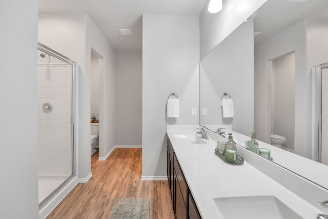 11355 Dawn Beach Ln, Conroe, TX 77304 - bathroom featuring toilet, wood finished floors, and a stall shower