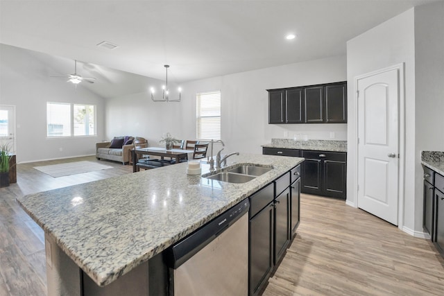 11355 Dawn Beach Ln, Conroe, TX 77304 - kitchen with stainless steel dishwasher, a sink, healthy amount of natural light, a kitchen island with sink, and vaulted ceiling