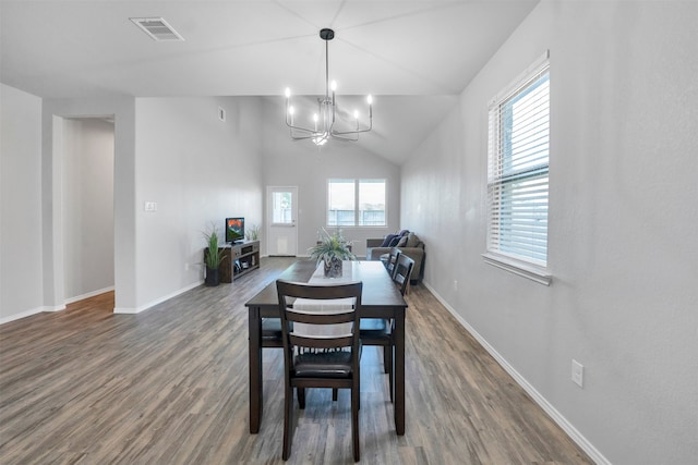 11355 Dawn Beach Ln, Conroe, TX 77304 - dining space featuring a chandelier, dark wood-type flooring, baseboards, and vaulted ceiling