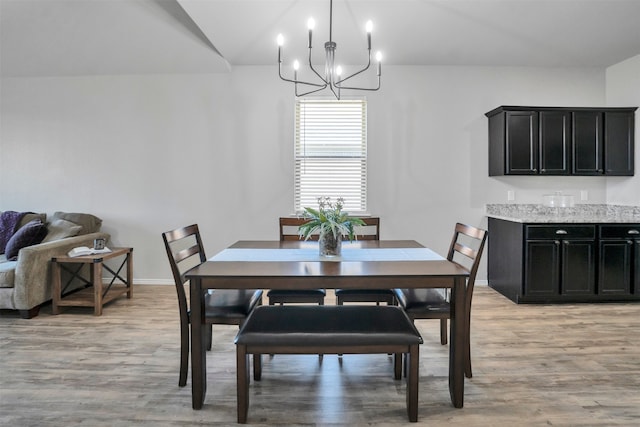 11355 Dawn Beach Ln, Conroe, TX 77304 - dining room featuring light wood-style floors, a chandelier, and baseboards