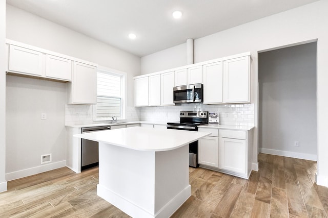 16912 Kempwood, Montgomery, TX 77316 - kitchen featuring stainless steel appliances, tasteful backsplash, a center island, light countertops, and recessed lighting