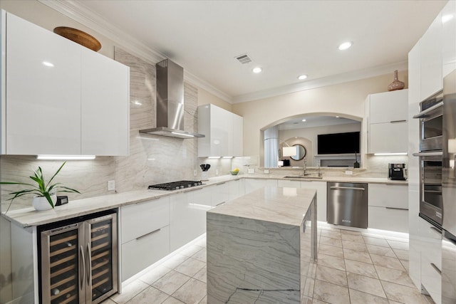 14402 Basalt Ln, Houston, TX 77077 - kitchen featuring modern cabinets, appliances with stainless steel finishes, wall chimney range hood, wine cooler, and crown molding