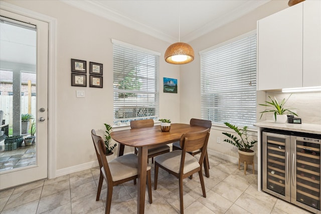 14402 Basalt Ln, Houston, TX 77077 - dining area featuring beverage cooler, crown molding, baseboards, and light tile patterned floors