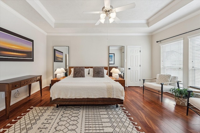 14402 Basalt Ln, Houston, TX 77077 - bedroom with a tray ceiling, multiple windows, hardwood / wood-style flooring, and ornamental molding