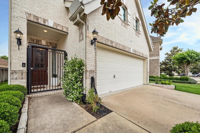14402 Basalt Ln, Houston, TX 77077 - property entrance featuring brick siding, an attached garage, and driveway