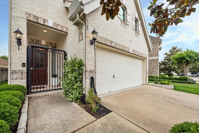 14402 Basalt Ln, Houston, TX 77077 - entrance to property with brick siding, a garage, and concrete driveway