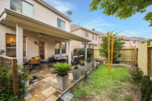 14402 Basalt Ln, Houston, TX 77077 - fenced backyard featuring an outdoor hangout area, ceiling fan, and a patio