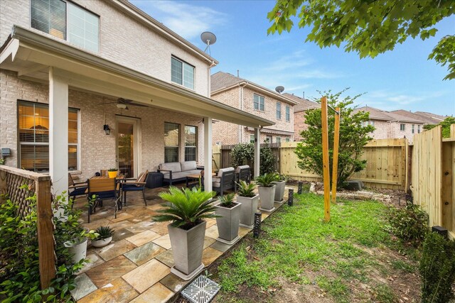14402 Basalt Ln, Houston, TX 77077 - fenced backyard featuring an outdoor hangout area, ceiling fan, and a patio area