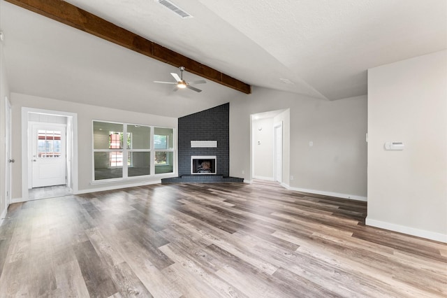 4434 Falcon Meadow Dr, Katy, TX 77449 - unfurnished living room with a ceiling fan, wood finished floors, baseboards, and a brick fireplace