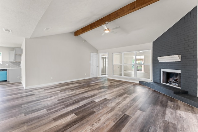 4434 Falcon Meadow Dr, Katy, TX 77449 - unfurnished living room featuring a ceiling fan, healthy amount of natural light, a brick fireplace, and wood finished floors