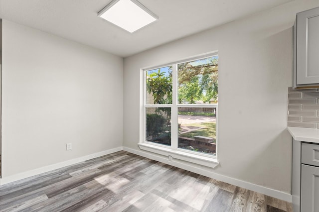 4434 Falcon Meadow Dr, Katy, TX 77449 - unfurnished dining area with baseboards and light wood finished floors