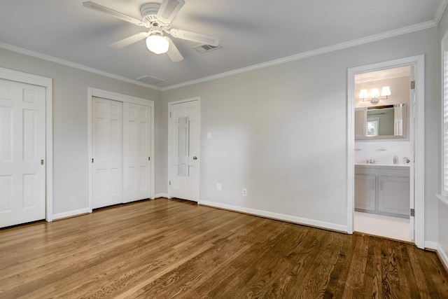 5215 Stillbrooke Dr, Houston, TX 77035 - unfurnished bedroom with wood finished floors, multiple closets, crown molding, connected bathroom, and baseboards