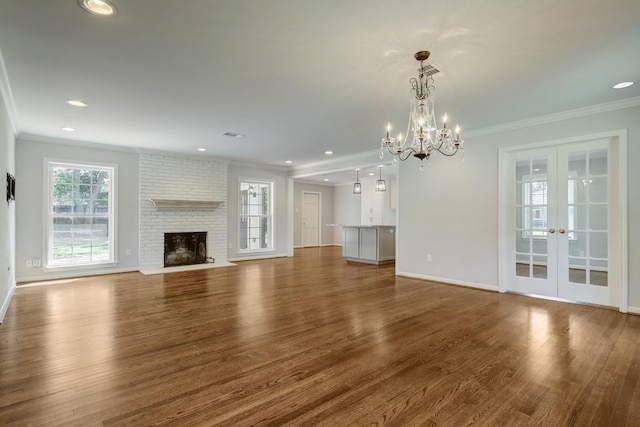 5215 Stillbrooke Dr, Houston, TX 77035 - unfurnished living room with french doors, crown molding, healthy amount of natural light, wood finished floors, and a chandelier