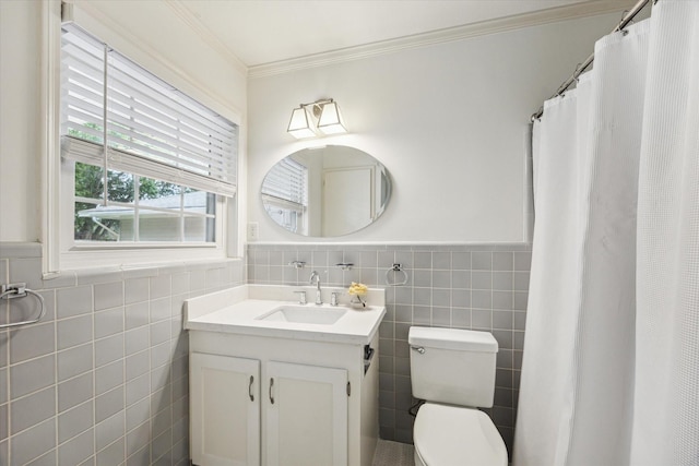 5215 Stillbrooke Dr, Houston, TX 77035 - full bathroom featuring tile walls, vanity, toilet, ornamental molding, and wainscoting