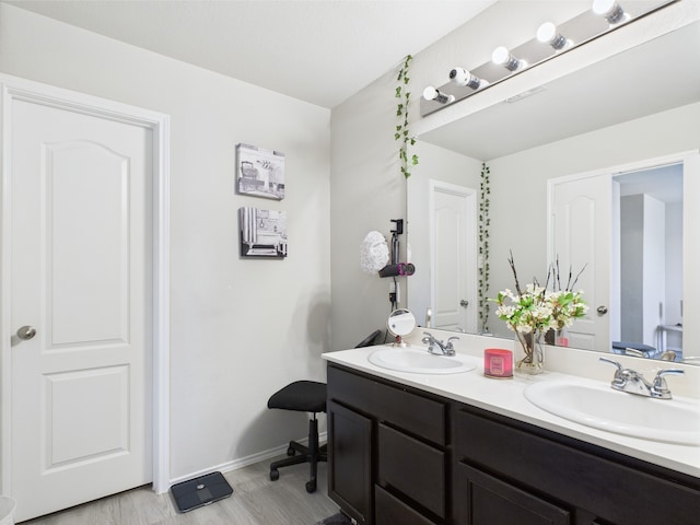 12671 Taymouth Manor Dr Unit 6, Humble, TX 77346 - bathroom featuring double vanity, wood finished floors, and baseboards