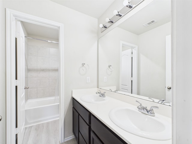 12671 Taymouth Manor Dr Unit 6, Humble, TX 77346 - full bath featuring double vanity, wood finished floors, and washtub / shower combination