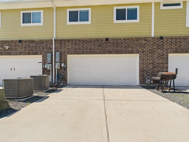 12671 Taymouth Manor Dr Unit 6, Humble, TX 77346 - garage featuring central AC unit and concrete driveway