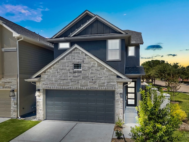 2906 Park Hill Ln, Stafford, TX 77477 - view of front facade featuring stone siding, concrete driveway, board and batten siding, and a garage