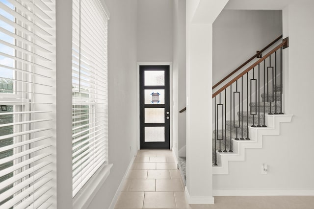 2906 Park Hill Ln, Stafford, TX 77477 - foyer entrance with light tile patterned floors, baseboards, and stairway