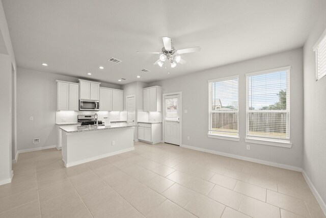 2906 Park Hill Ln, Stafford, TX 77477 - kitchen with appliances with stainless steel finishes, ceiling fan, baseboards, recessed lighting, and light tile patterned floors
