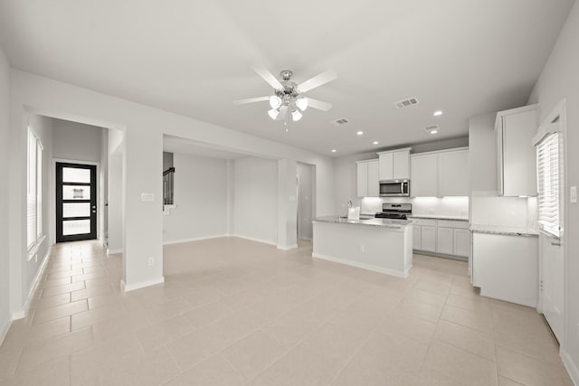 2906 Park Hill Ln, Stafford, TX 77477 - kitchen with appliances with stainless steel finishes, healthy amount of natural light, a ceiling fan, light tile patterned flooring, and recessed lighting