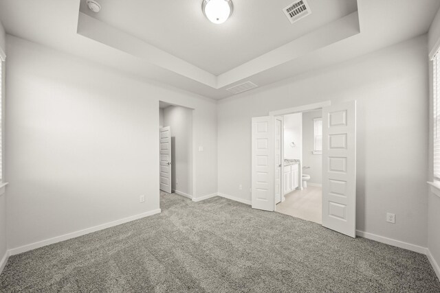 2906 Park Hill Ln, Stafford, TX 77477 - unfurnished bedroom featuring a raised ceiling, carpet, and baseboards