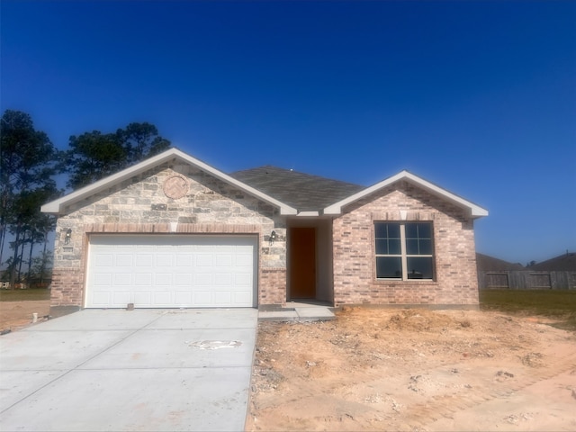 ranch-style home with a garage, brick siding, and concrete driveway