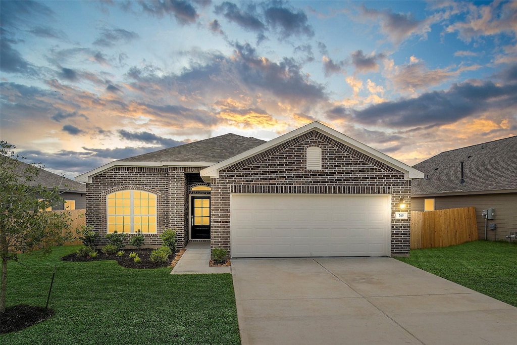 769 Dewberry Ln, Marque, TX 77568 - view of front of house featuring brick siding, an attached garage, concrete driveway, and a shingled roof