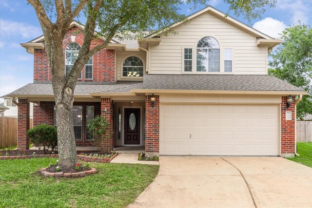 1056 Inverness Cv, Dickinson, TX 77539 - traditional home with brick siding, concrete driveway, a garage, and roof with shingles