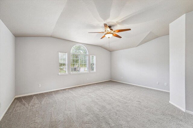 1056 Inverness Cv, Dickinson, TX 77539 - carpeted empty room featuring vaulted ceiling, ceiling fan, and baseboards